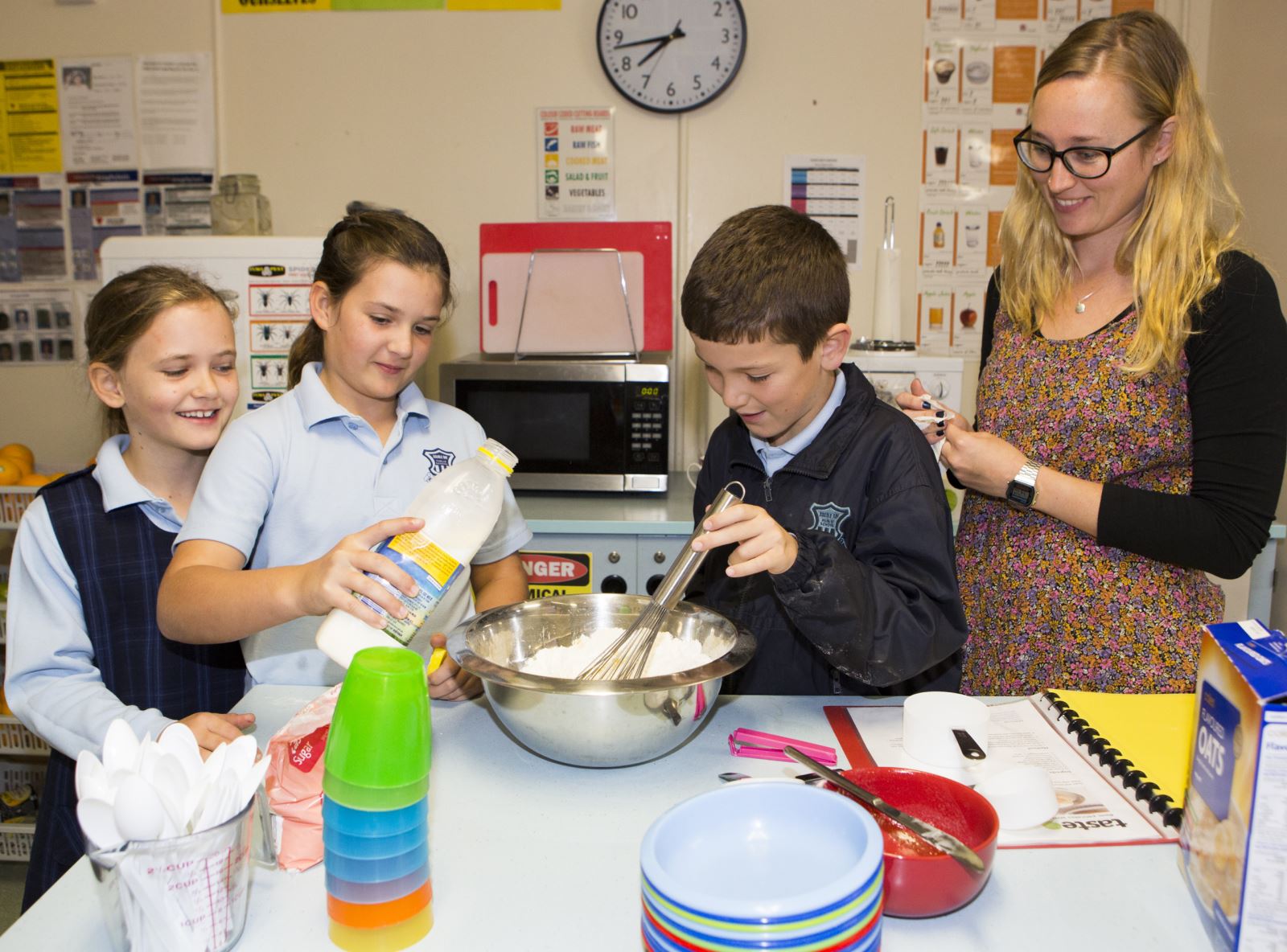 educator and children in kitchen image
