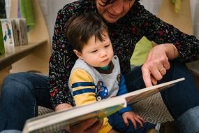 KU Lance educator reading with toddler