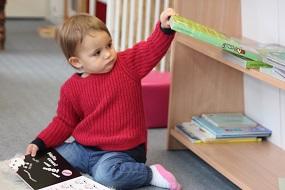 baby playing with books