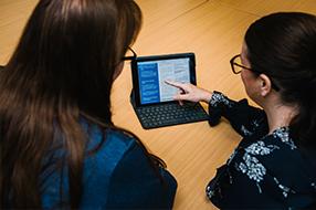 Two educators looking at a tablet together