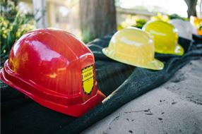 Safety hard hats sitting on wall