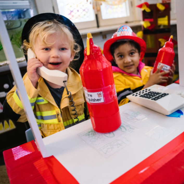 Children dress up play firefighters